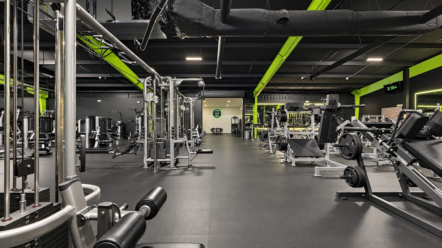 Free weight area with benches and racks at TNU Fitness