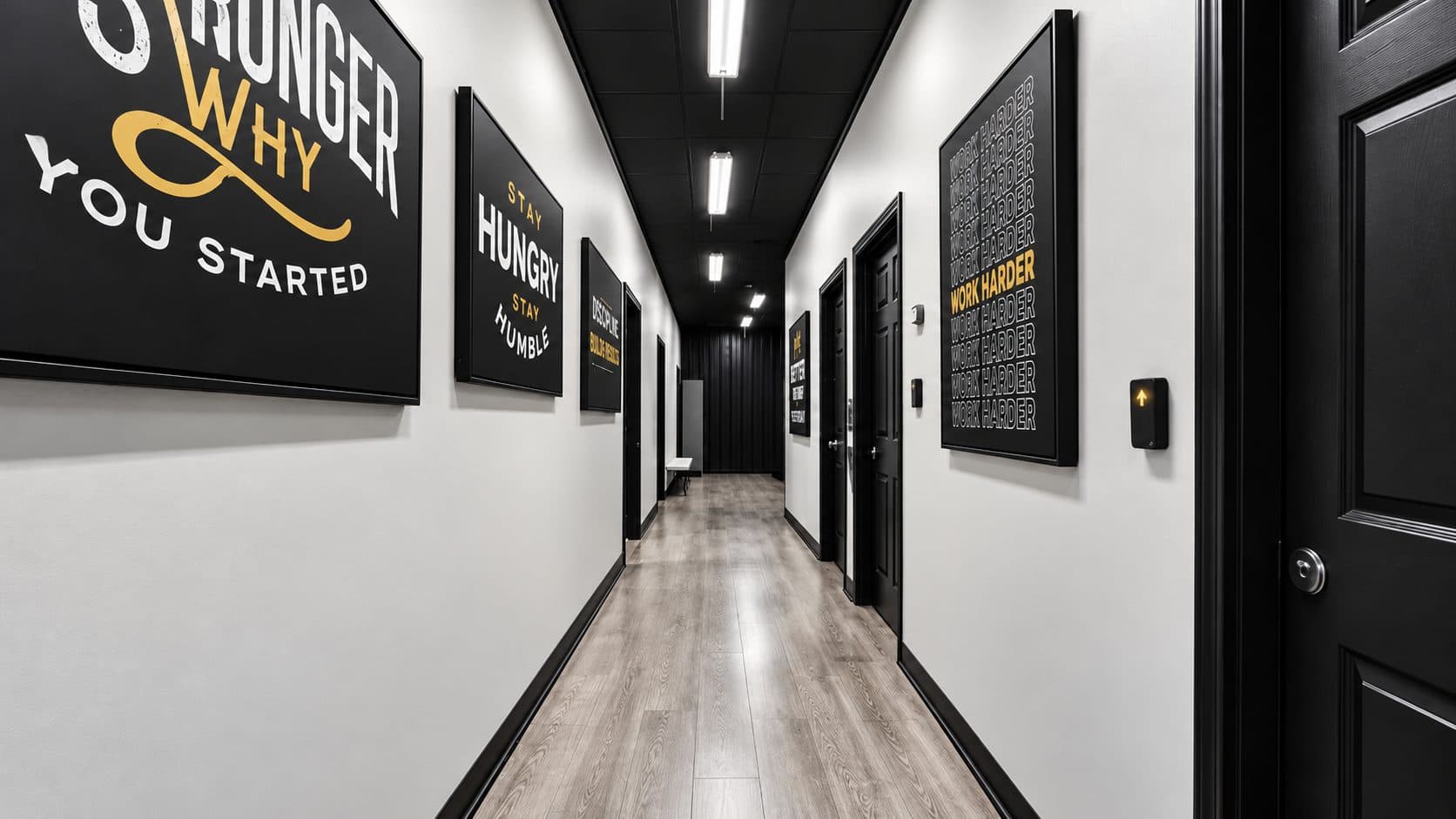 Hallway lined with motivational prints at TNU Fitness